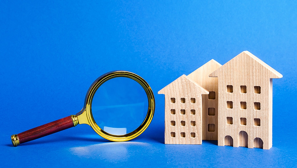 magnifying glass and wooden apartments